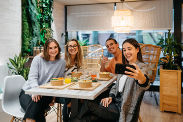 Group of smiling friends taking a selfie