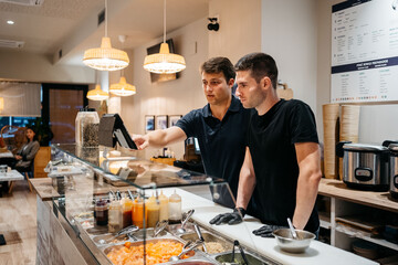 Restaurant young managers are checking the online orders