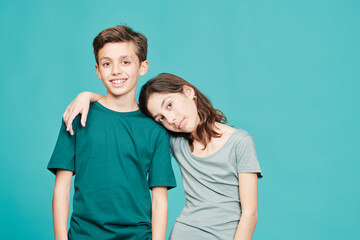 Embracing boy and girl on blue background