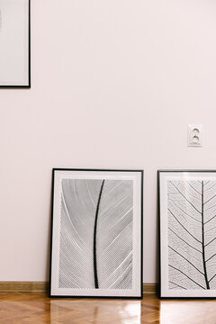 Photographs ready to be hanged on a freshly drilled wall