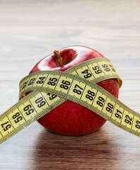 A red Apple is measured by a meter. Slimness and diet.