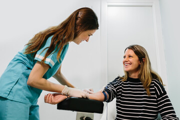 Nurse performing a blood draw to a patient