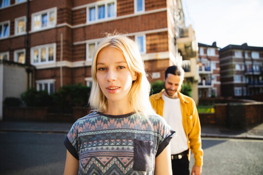 Portrait of a young woman with her boyfriend behind her