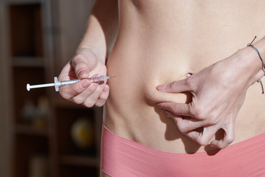 Girl making abdomen injection at home