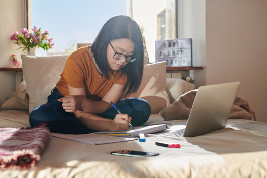 Asian girl studying at home