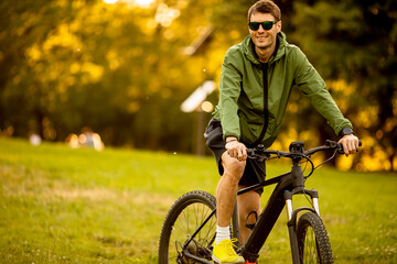 Young man riding ebike in the park