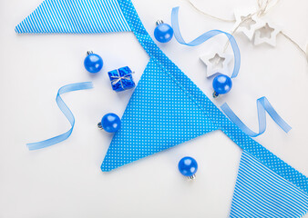 Blue Christmas composition. Blue Christmas balls, blue garland and stars on a white background.