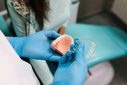 Crop doctor with invisible brace and denture at workplace