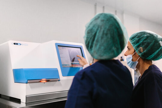 Biologists working with professional equipment in IVF laboratory