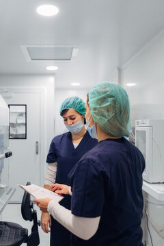Biologists working reviewing documents in IVF laboratory