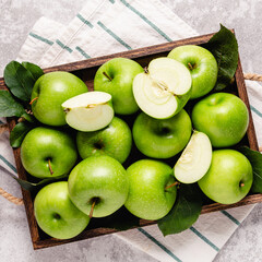 Ripe green apples in wooden box.