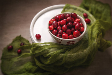 Bowl of Fresh Cranberries on a White Pedestal