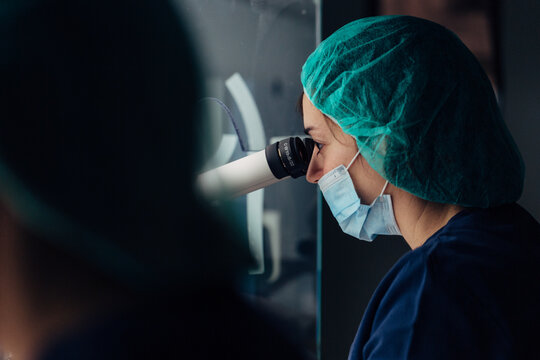 Biologist working on microscope in IVF laboratory