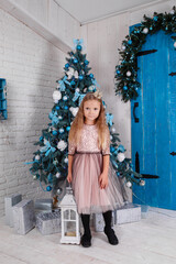 Fototapeta na wymiar a cute little girl in a dress getting ready for New Year's.