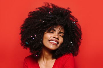 Beautiful afro woman posing over red background