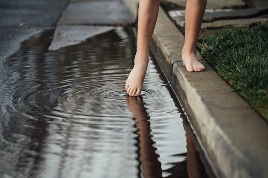 Girl Playing with Puddle