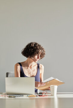 Business woman sitting at table with folder