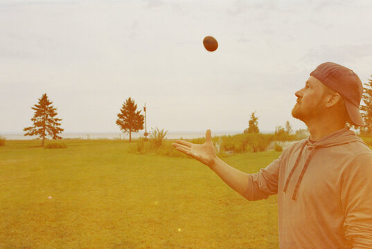 Man throwing a hot potato in the air