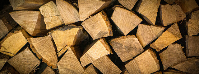 stacked light firewood as a background with dark vignetting at the edges