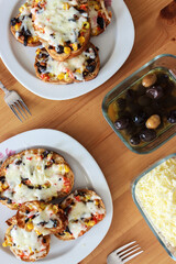 Top view of Turkish breakfast on wooden background. Pizza, olive and cheese on the table.