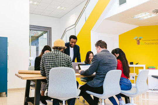 Diverse business people at table in modern office