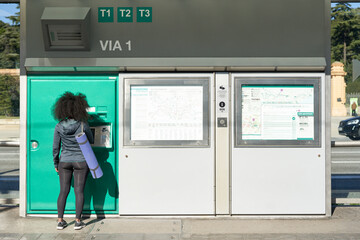 Sportswoman getting a ticket at the machine.