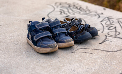 two pairs of used children's shoes left behind