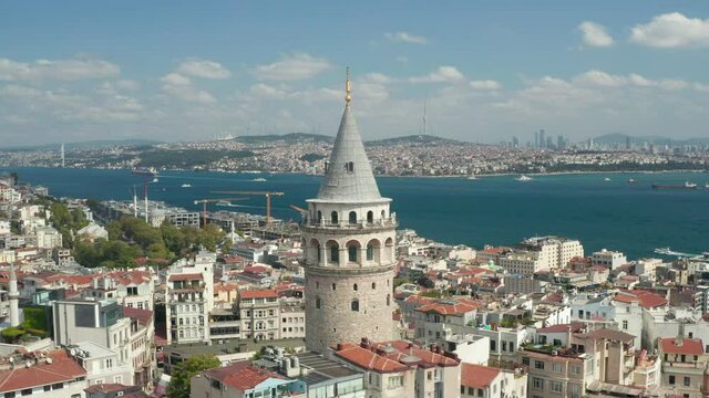 Slowly circling around Galata Tower in Istanbul, Turkey with view over Skyline and Bosphorus, Slow Aerial Drone View