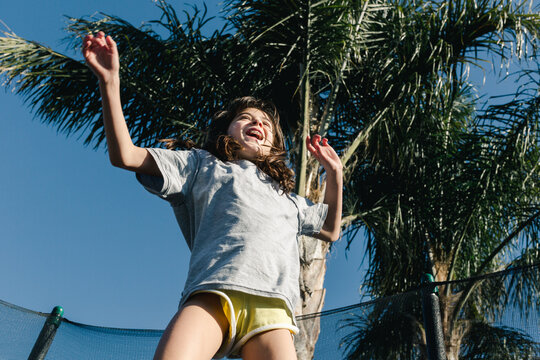 Girl Jumping in Trampoline
