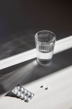 Glass of water with tablets