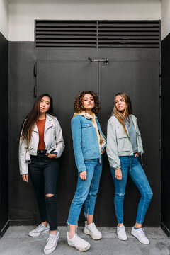 Casual teens posing on black wall background