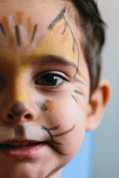 Adorable boy with infant makeup on his face.