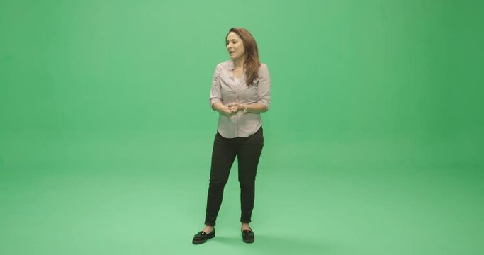 Studio, slow motion, green screen, young female welcomes her audience, London, UK