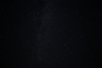 Starry night black sky fully with glowing stars of Milky way. Real astro photo on summer night.