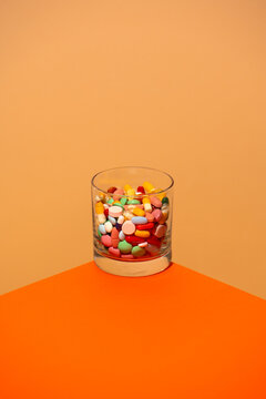Colorful pills in a glass