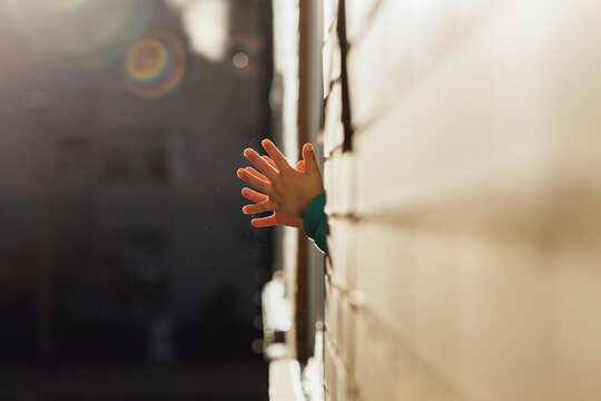 Unrecognizable little boy applauding in his window in gratitude to the health personnel and other groups during the confinement for the coronavirus