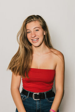 Studio portrait of cute teen girl with brackets