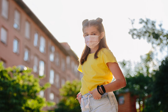 Portrait of girl wearing pink mask