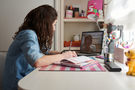 Teenage girl video chatting with friend