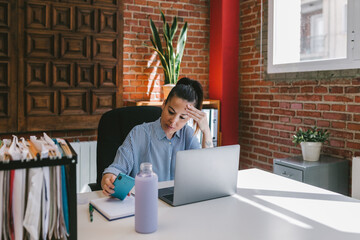Busy young businesswoman working at the office
