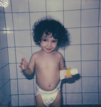 Polaroid photo of kid inside a shower.
