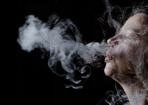 Closeup of woman's face enjoying smoking