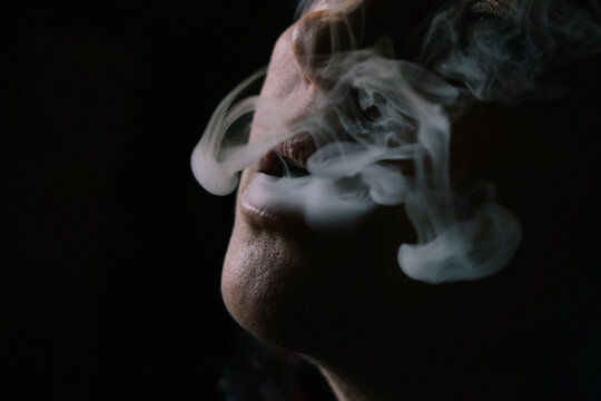 Closeup of woman's mouth enjoying smoking