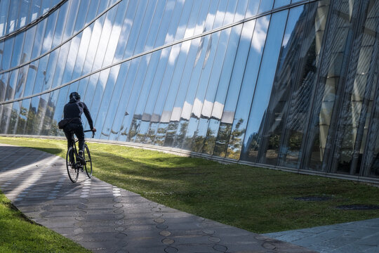 Urban cyclist in rides in modern city