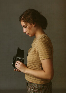 Woman with vintage camera in profile