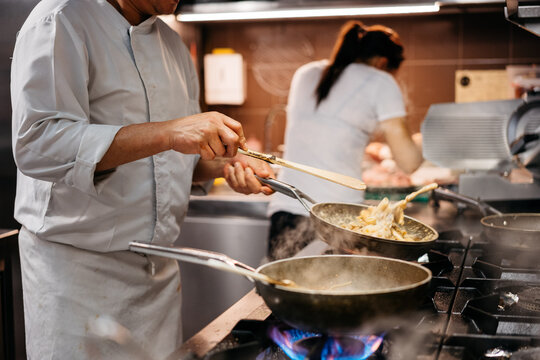 Anonymous chef cooking some italian dishes