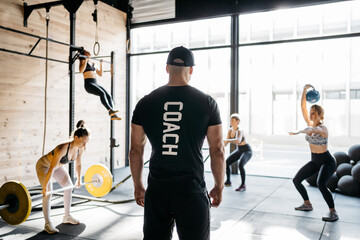 Coach checking the women crossfit training