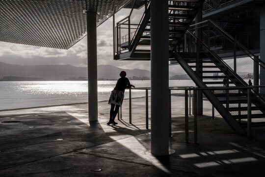 Woman leaning looking at the sea