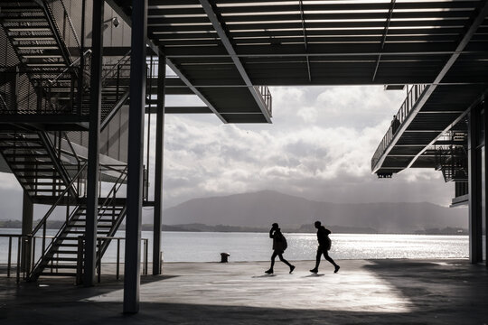 Two young men walk in futuristic setting