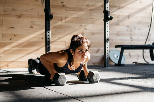 Woman doing push ups in a crossfit box